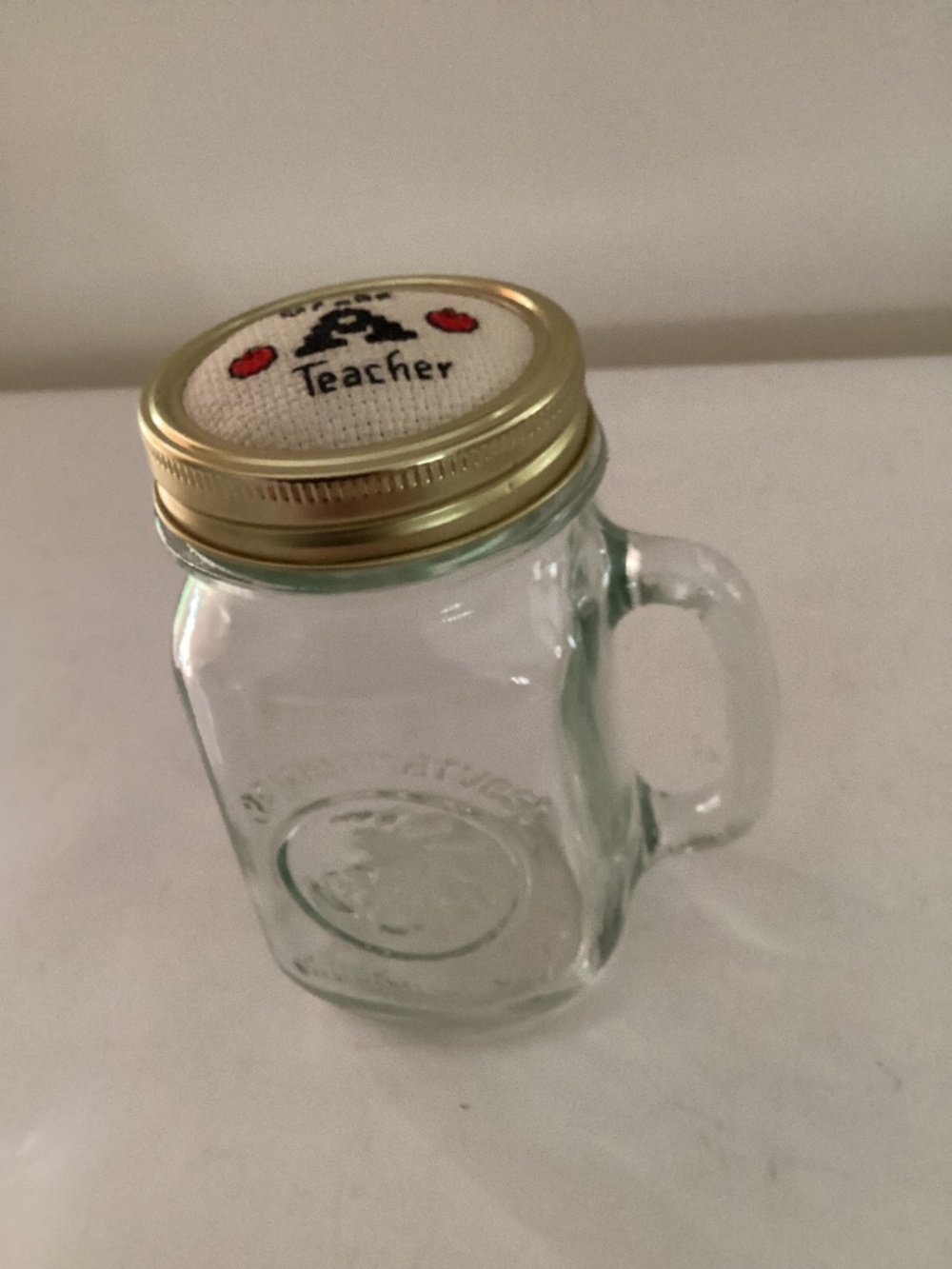 Hand embroidered top on one pint mason jar with handle
